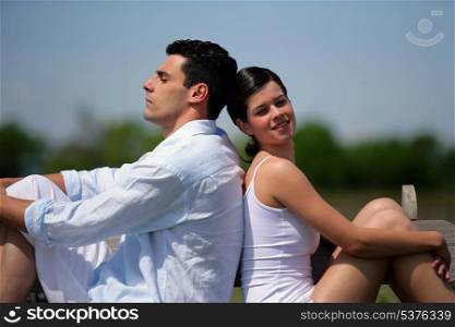 Young couple sitting in the sunshine
