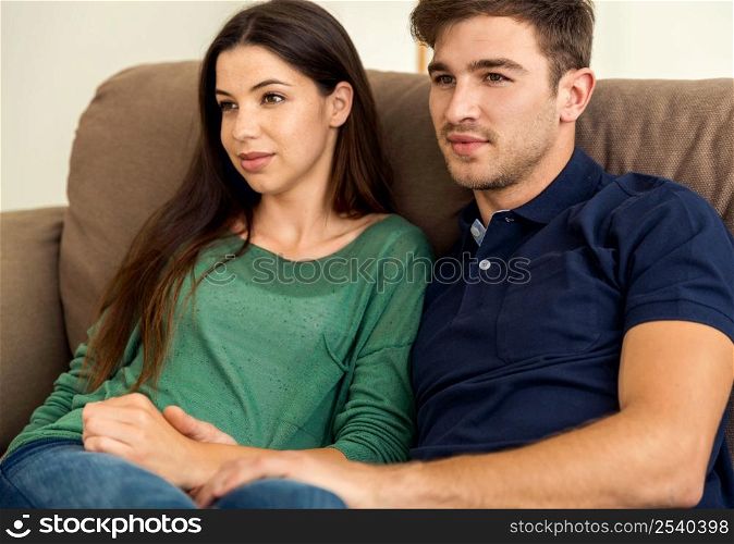Young couple sitting on the sofa and dating