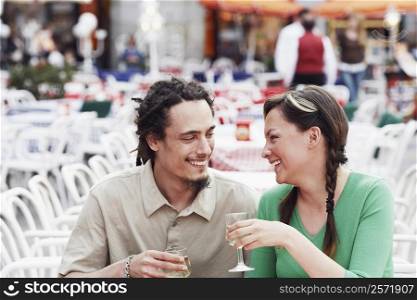 Young couple sitting together at a sidewalk cafe
