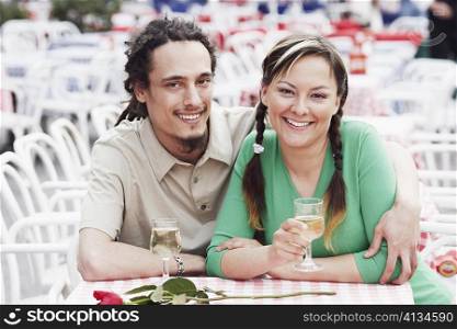 Young couple sitting together at a sidewalk cafe