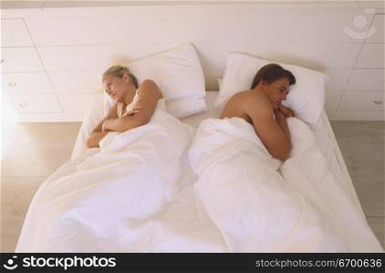 Young couple sleeping on a bed