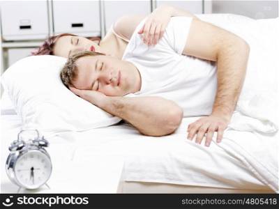 Young couple sleeping peacefully in the bed. Sprouts in bed