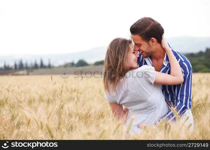 young Couple smiling eachotherr in the meadow