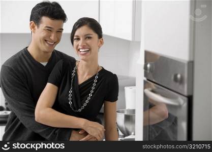 Young couple smiling in the kitchen