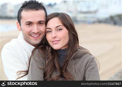 Young couple spending a week-end at the beach in winter