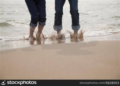 Young Couple Splashing in the Waves