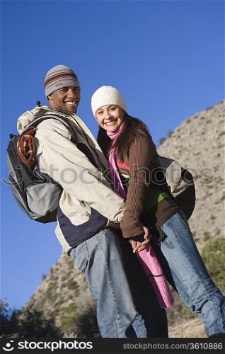 Young couple stand holding hands