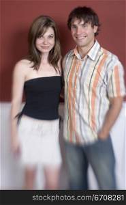 Young couple standing and smiling