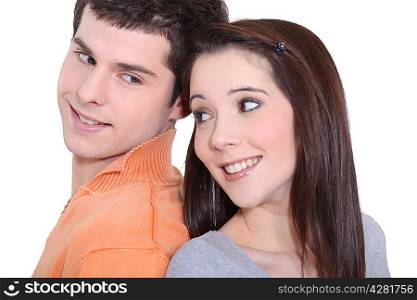 Young couple standing back to back