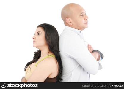 Young couple standing back to back having relationship difficulties on white background