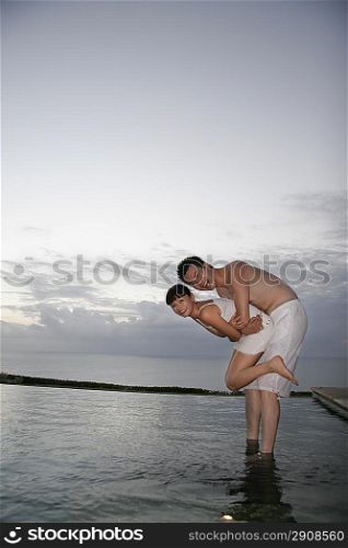 Young couple standing in water