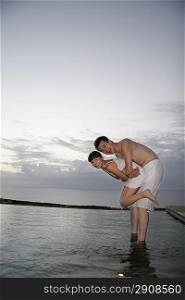 Young couple standing in water
