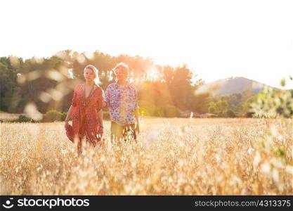 Young couple standing in wheat field, Majorca, Spain