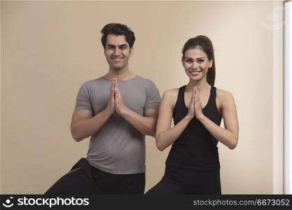 Young couple standing in yoga position