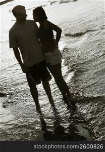 Young couple standing on the beach