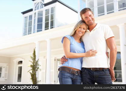 Young Couple Standing Outside Dream Home