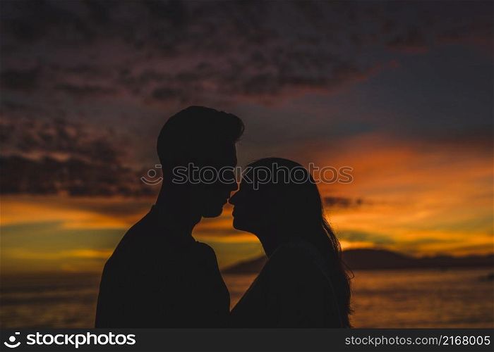 young couple standing sea shore night