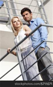 Young couple standing together at hotel balcony