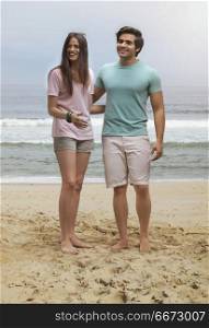 Young couple standing together on beach