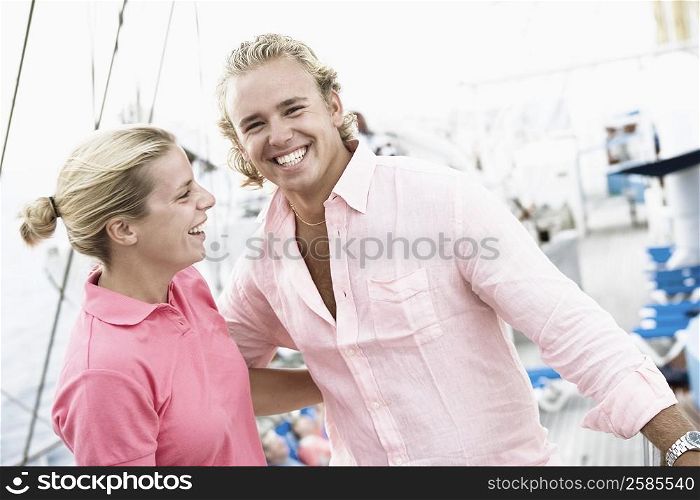 Young couple standing with their arms around each other and smiling