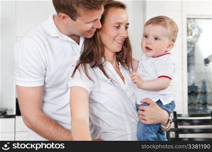 Young couple standing with their cute child