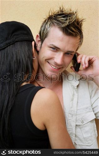 Young couple stood by wall