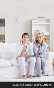 Young couple switches TV channels