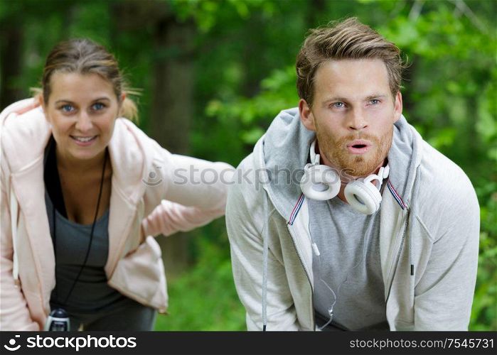 young couple taking a breather from exercise outdoors