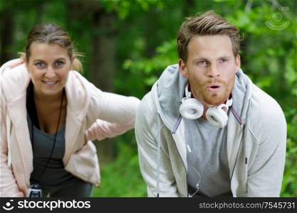 young couple taking a breather from exercise outdoors