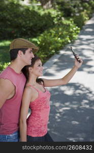 Young couple taking a photograph of themselves with a mobile phone