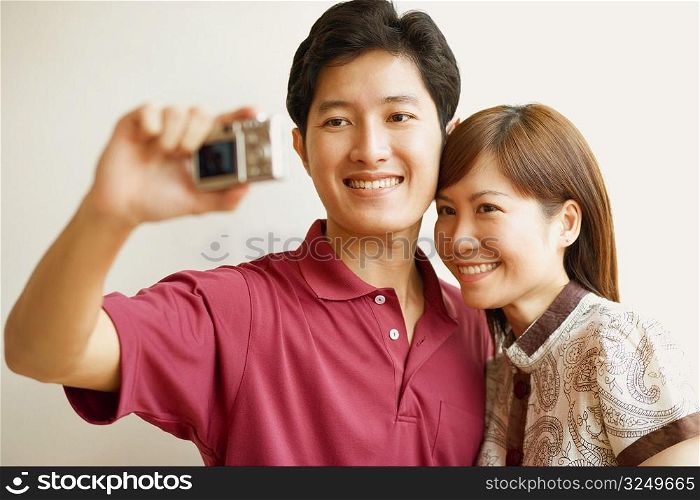 Young couple taking a picture of themselves