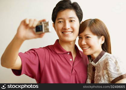 Young couple taking a picture of themselves