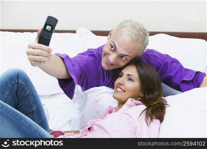 Young couple taking a picture of themselves with a mobile phone