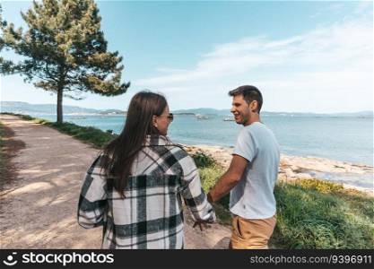 Young couple taking a walk near the ocean in Galicia, Spain