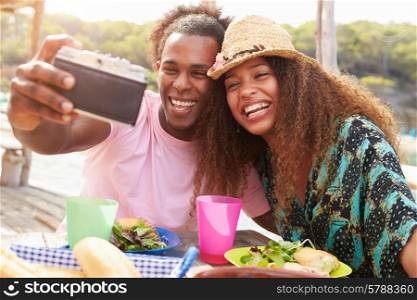 Young Couple Taking Selfie During Lunch Outdoors