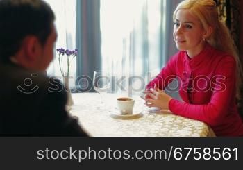 Young couple talking in a coffee shop or restaurant