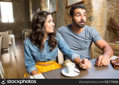 Young couple talking in restaurant and cafe