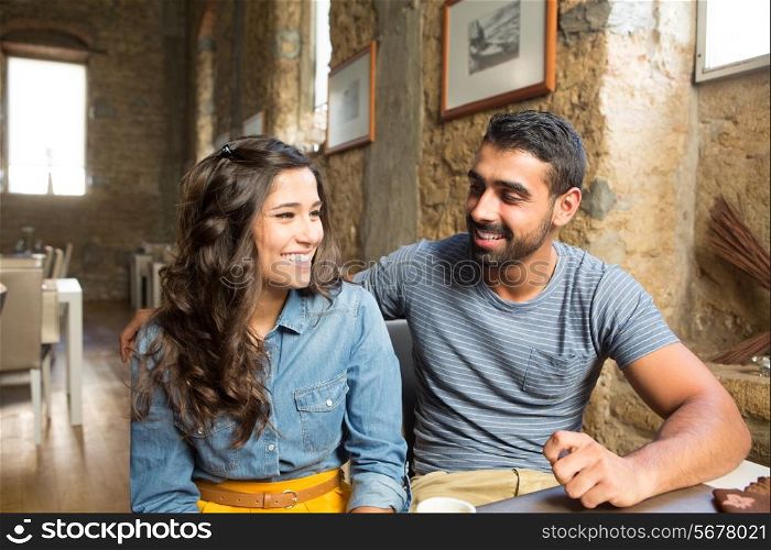Young couple talking in restaurant and cafe