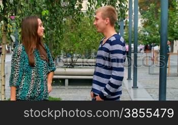 young couple talking in the park.