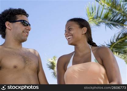 Young couple talking on beach