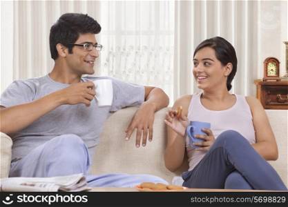 Young couple talking while having coffee
