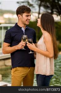 Young couple tasting wine near by the pool on a hotel