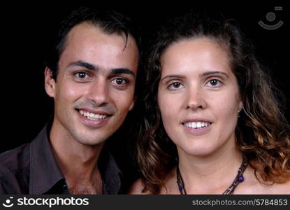 young couple together portrait on black background