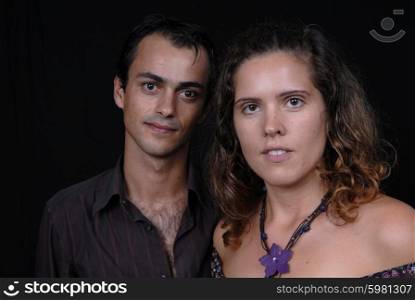 young couple together portrait on black background