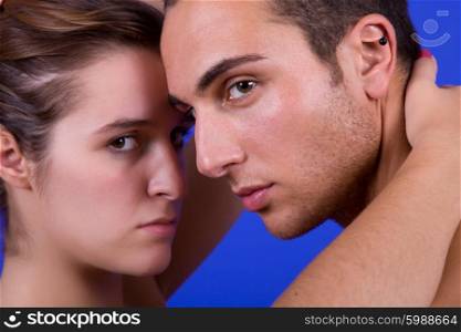 young couple together portrait on blue background
