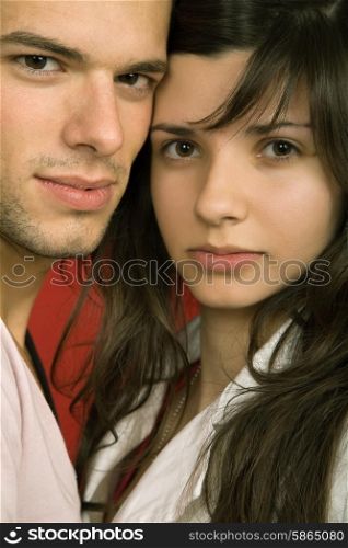 young couple together portrait on red background