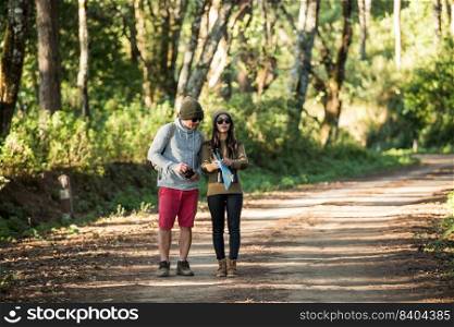 Young couple tourist travel in mountain forest