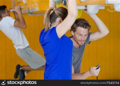 young couple training together in the gym
