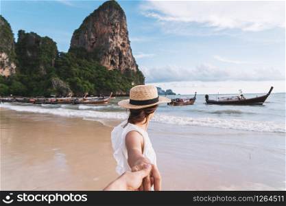 Young couple traveler enjoying a summer vacation at tropical sand beach in Krabi, Thailand
