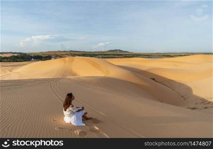 Young couple traveler looking beautiful landscape at white sand dunes in Vietnam, Travel lifestyle concept